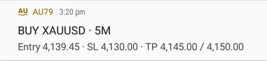A BUY XAUUSD 5M alert from AU79 in the phone's notifications